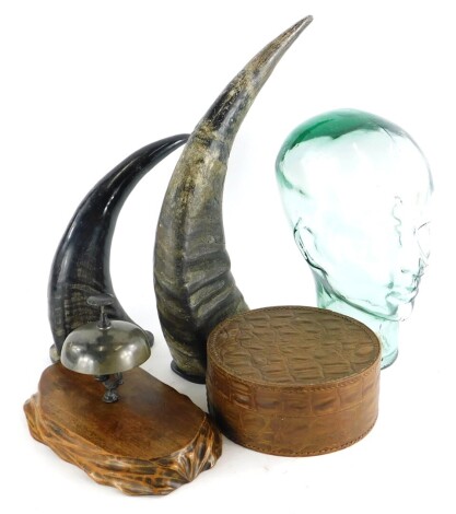 A moulded glass shop display head, 30cm high, a cast brass desk bell, leather collar box and two resin imitation rhino horns. (5)