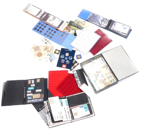 A quantity of stamps, mainly First Day covers, some coin trays, loose stamps, etc.