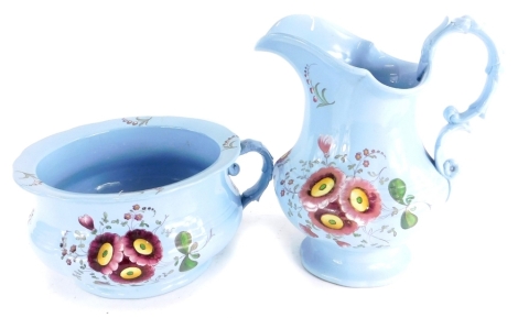 A 19thC Staffordshire blue glazed pottery wash jug and chamber pot, each decorated in coloured enamels with flowers, unmarked, the jug 27cm high.