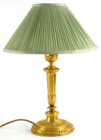 A late 19th/early 20thC French gilt metal lamp base, with fluted column cast with leaves, etc., 44cm high.