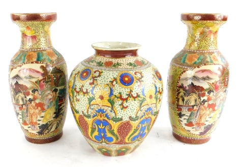 A pair of late Chinese vases, printed and painted with figures, etc., 26cm high, and a vase decorated with flowers, etc. (3)