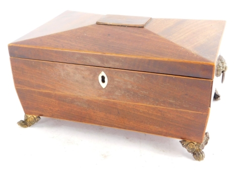 A mid 19thC mahogany and boxwood strung sarcophagus shaped workbox, the hinged lid enclosing a lined interior with gilt metal handles and feet, 25cm wide.