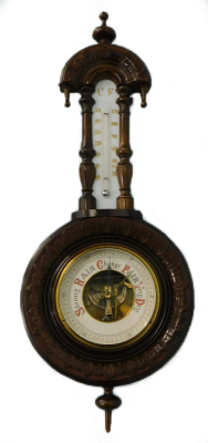 A Victorian walnut cased aneroid barometer, with carved case and ceramic thermometer, 55cm high.