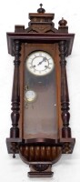 A late 19thC Vienna type wall clock, in a walnut case with a white enamel dial flanked by part reeded pilasters, 93cm high. (AF)