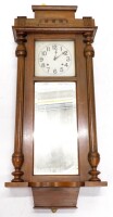 An early 20thC oak cased wall clock, the painted dial with Arabic numerals, the case with reeded pilasters, 110cm high.