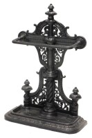 A Victorian cast iron umbrella stand, with pierced decoration to the raised back and shaped beaded drip tray, on a leaf moulded D shaped base, registration number to reverse, 83cm high, 54cm wide.