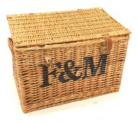 A Fortnum and Mason wicker hamper, with leather straps, 55cm wide.