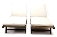 A pair of hardwood adjustable garden loungers, each with a padded cushion, 196cm long.