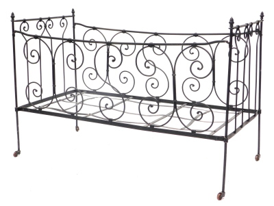 A Victorian wrought iron folding child's cot or bed, with scroll decoration, later painted black, 118cm wide.