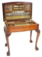 An early to mid 20thC canteen of cutlery, the mahogany bow fronted case, with a gadrooned border to the hinged lid, enclosing Old English pattern cutlery, with label for George Butler and Co Limited of Sheffield, on shell carved cabriole legs with ball an