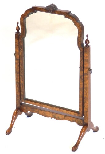 A walnut dressing mirror, in mid 18thC style, with arched shaped plate on square tapering end supports with turned finials and cabriole legs, 40cm wide.