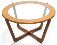 A G-Plan type teak coffee table, the circular top with a smoked glass insert, on X shaped support, 79cm diameter.