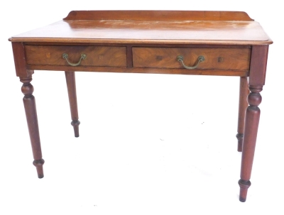 A mahogany table, with a raised back above two frieze drawers, on turned tapering legs, 70cm high, 104cm wide.