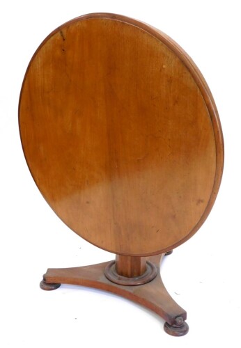 A Victorian mahogany breakfast table, the circular top with a moulded edge, on an octagonal tapering column and triform base with bun feet, 101cm diameter.