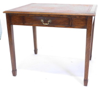 An oak and mahogany writing table, the top with a brown leather inset and moulded edge, above an associated frieze drawer on square tapering legs, 91cm wide.