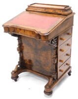 A Victorian walnut and marquetry Davenport, the hinged top with a fitted interior for letters, etc., above a fall with red leather inset enclosing a fitted interior, above side drawers each with turned wood handles, on part turned supports, with shaped ba