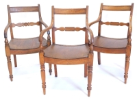 A pair of early 19thC elm country made open armchairs, each with a shaped back support with central tablet, a solid saddled shaped seat on turned tapering legs, and another similar. (3)