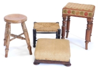 A Victorian mahogany stool, with a wool work seat, on part turned splayed legs, a small foot stool, a country made stool and an ebonised stool. (4)