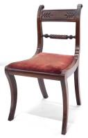 A Regency mahogany side chair, with a rope twist back scroll carved back supports, and a drop in seat on sabre legs.