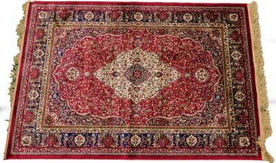 A red ground Kashmere type rug, with a design of a cream medallion, on a red ground with blue spandrels and one wide and two narrow borders, 170cm x 120cm.