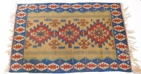 An Eastern Turkish Kilim rug, with a typical geometric design in brown, red, blue and yellow, 109cm x 175cm.