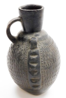 A Chinese pottery ovoid ewer with single handle and relief decorated body, 19thC or earlier, 20cm high. - 26