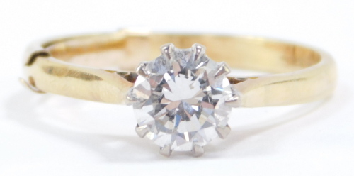 A diamond solitaire ring, high claw set in yellow metal, stamped 18ct, approx 1ct, size Q, 3.6g.