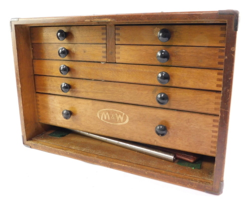 A Moore & Wright oak cased mechanical tool chest, containing micrometres, calipers and other precision instruments, the fall flap opening to reveal four short and three long graduated drawers, with carrying handle.