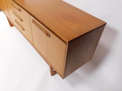 A Portwood Furniture vintage teak sideboard, with three central drawers flanked by a pair of cupboard doors, raised on U shaped ends, 75cm high, 184cm wide, 44cm deep. - 4