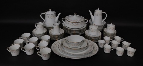 A Noritake porcelain part dinner tea and coffee service decorated in the Estrellita pattern, comprising a pair of graduated meat platters, integrated sauce boat on stand, oval serving dish, vegetable tureen and cover, eight dinner, dessert and side plates