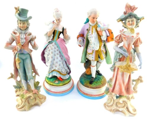 A pair of 19thC Continental bisque porcelain figures of a lady and gentleman, holding love birds, and painted in pastel colours enriched in gilt, 36cm high, together with a further pair. (4)