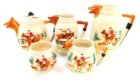 An early 20thC Portland Pottery Company pottery tea and coffee hunting service, moulded with fox mask spouts.