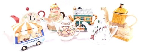 A group of character teapots, comprising a Tony Wood camel teapot., Angler teapot., Arthur Wood Cream Tea teapot., clock face teapot., Refreshments Van teapot., Wade Apres Ski teapot, and a Coronation Street Rovers Return teapot. (AF) (7) N.B. Please not