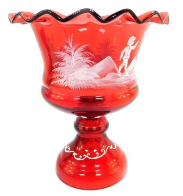 A Victorian cranberry glass vase, decorated in the Mary Gregory style, having a wavy rim and a band of a figure in landscape with bird to the bowl, and scrolls to stepped base, 26cm high.