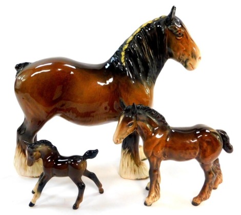 Two Beswick pottery foals, and a associated pottery shire horse. (3)