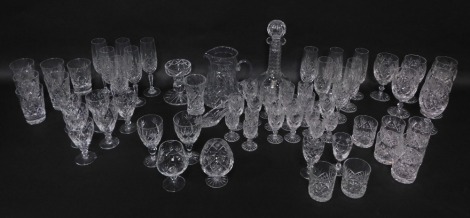 An extensive suite of cut crystal drinking glasses, together with a 'Georgian Crystal' globe and shaft decanter, ornamental shoe, and a water jug (AF). (a quantity)