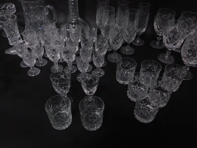 An extensive suite of cut crystal drinking glasses, together with a 'Georgian Crystal' globe and shaft decanter, ornamental shoe, and a water jug (AF). (a quantity) - 3