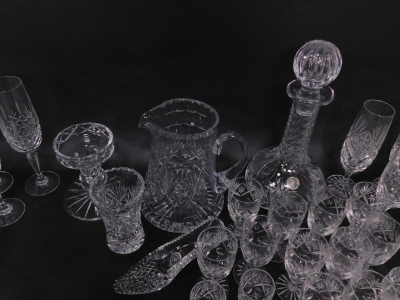 An extensive suite of cut crystal drinking glasses, together with a 'Georgian Crystal' globe and shaft decanter, ornamental shoe, and a water jug (AF). (a quantity) - 4