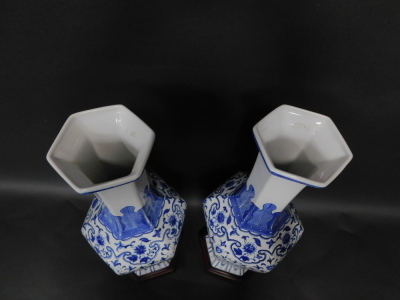 A pair of Chinese blue and white hexagonal baluster vases, decorated in a floral blue and white pattern with lappet shoulders, 62cm high with integral base. - 2