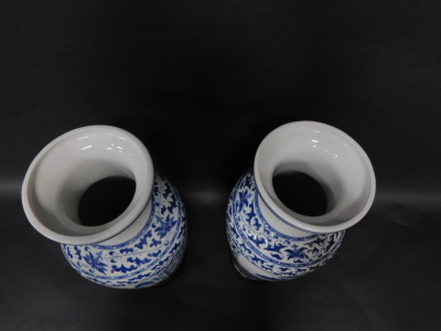 A pair of Chinese porcelain baluster vases, having blue and white landscape decoration, 54cm high with attached base. - 3