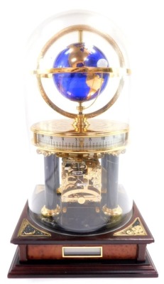 A Chinese brass and marble astrolabium clock, showing the globe and moon, cylindrical twenty four hour dial, raised on Doric columns, above a square mahogany base, with glass dome, 32cm high.