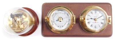 A Royal Mariner brass two dial wall clock and barometer, the clock with quartz movement, the case of porthole form on a wooden backing, 29cm wide., together with a Sewills barometer with thermometer and hygrometer, under a plastic dome, 17cm high. (2) - 2