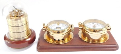 A Royal Mariner brass two dial wall clock and barometer, the clock with quartz movement, the case of porthole form on a wooden backing, 29cm wide., together with a Sewills barometer with thermometer and hygrometer, under a plastic dome, 17cm high. (2) - 3