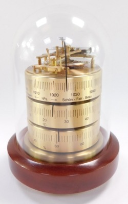 A Royal Mariner brass two dial wall clock and barometer, the clock with quartz movement, the case of porthole form on a wooden backing, 29cm wide., together with a Sewills barometer with thermometer and hygrometer, under a plastic dome, 17cm high. (2) - 7