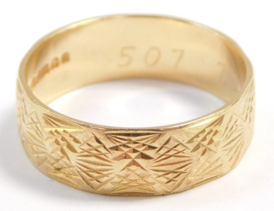 An 18ct gold wedding band, with engraved and faceted decoration, size R, 4.9g. - 3