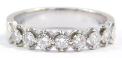 A diamond seven stone half hoop eternity ring, set in white metal, stamped 18k, approximately a 0.25ct, size M, 3.5g. - 2