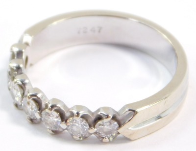 A diamond seven stone half hoop eternity ring, set in white metal, stamped 18k, approximately a 0.25ct, size M, 3.5g. - 4