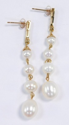 A pair of cultured pearl and diamond drop earrings, each earring set with four graduated pearls, in yellow metal stamped 14K. - 2