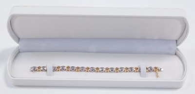 A baguette diamond bracelet, set in a white oval and yellow square metal link bracelet, stamped 14k, on a snap clasp, approximately 2ct, 18.3g. - 2