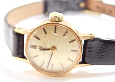 An Omega 9ct gold cased lady's wristwatch, circular champagne dials with gold batons, on a leather strap. - 3